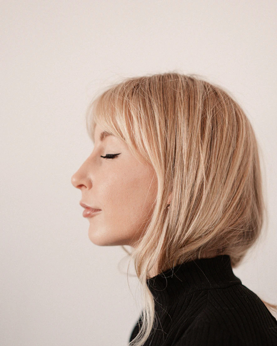 Woman in profile against a neutral backdrop