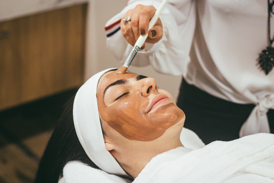 Clay mask applied during a clinical facial