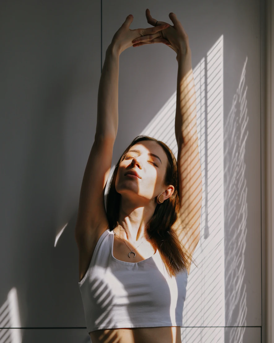 Woman stretching in soft morning light