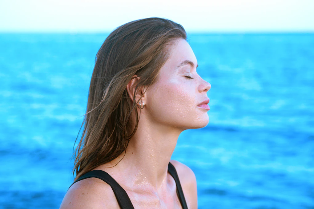 Woman in profile by the water